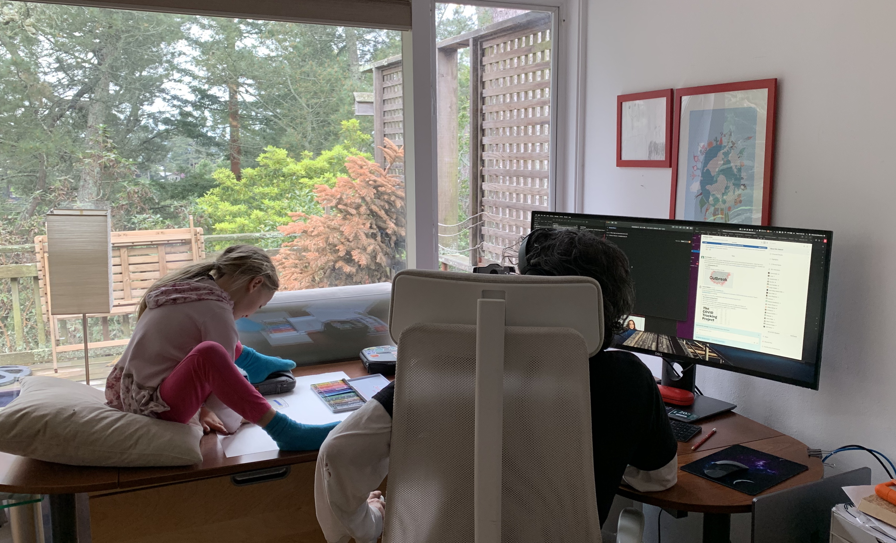 Father working with daughter drawing on the left