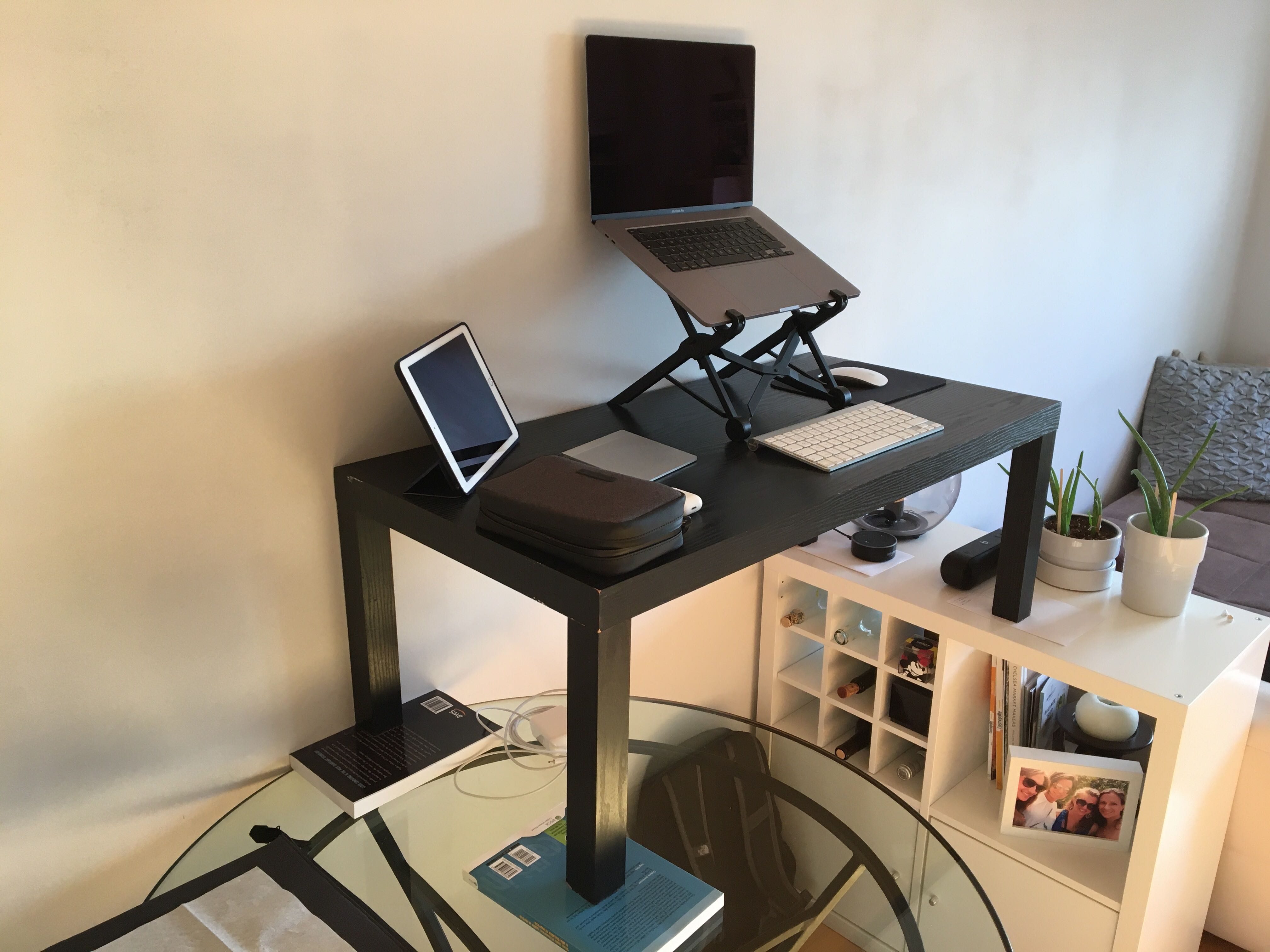 Coffee table stacked on top of dining table as a standing desk