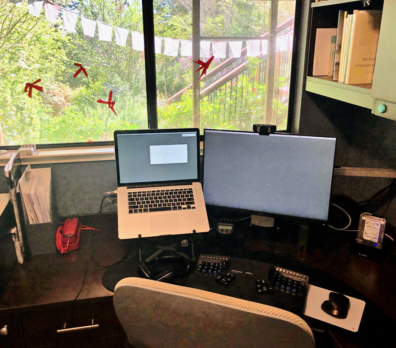 Home office by the window with red phone on the left