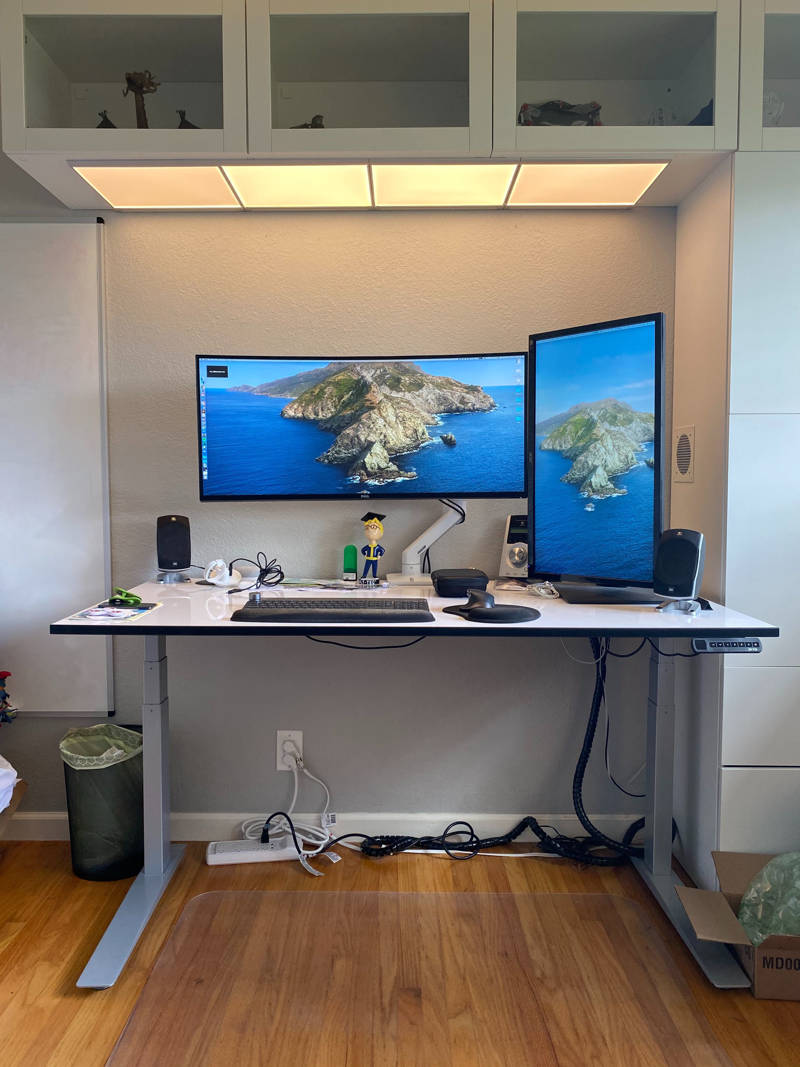 Workstation with a curved ultra wide screen monitor and a vertical monitor