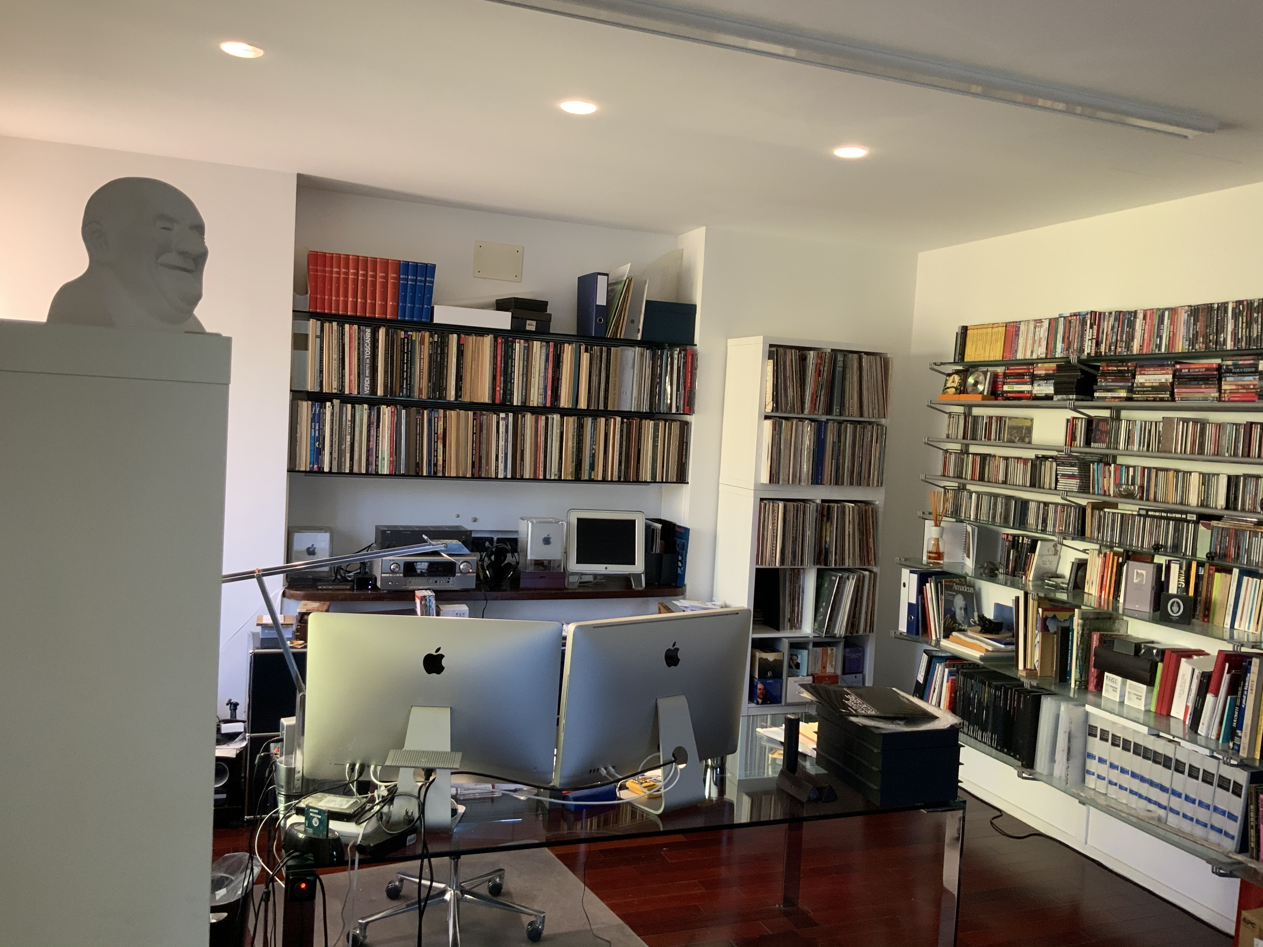 Home office with walls of books, movies, and vinyl records