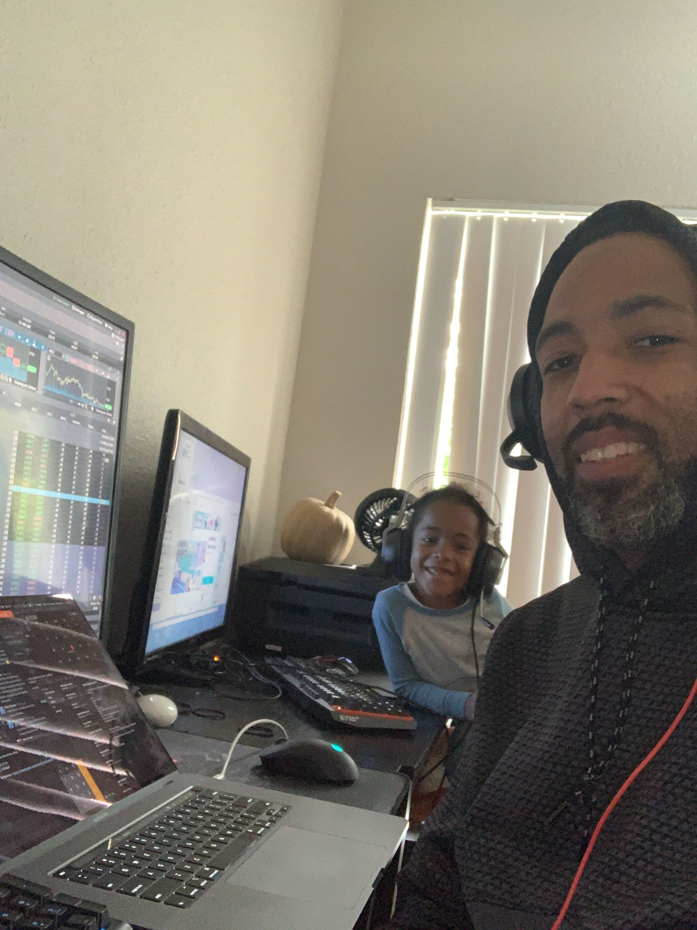 Father and son enjoying music while working