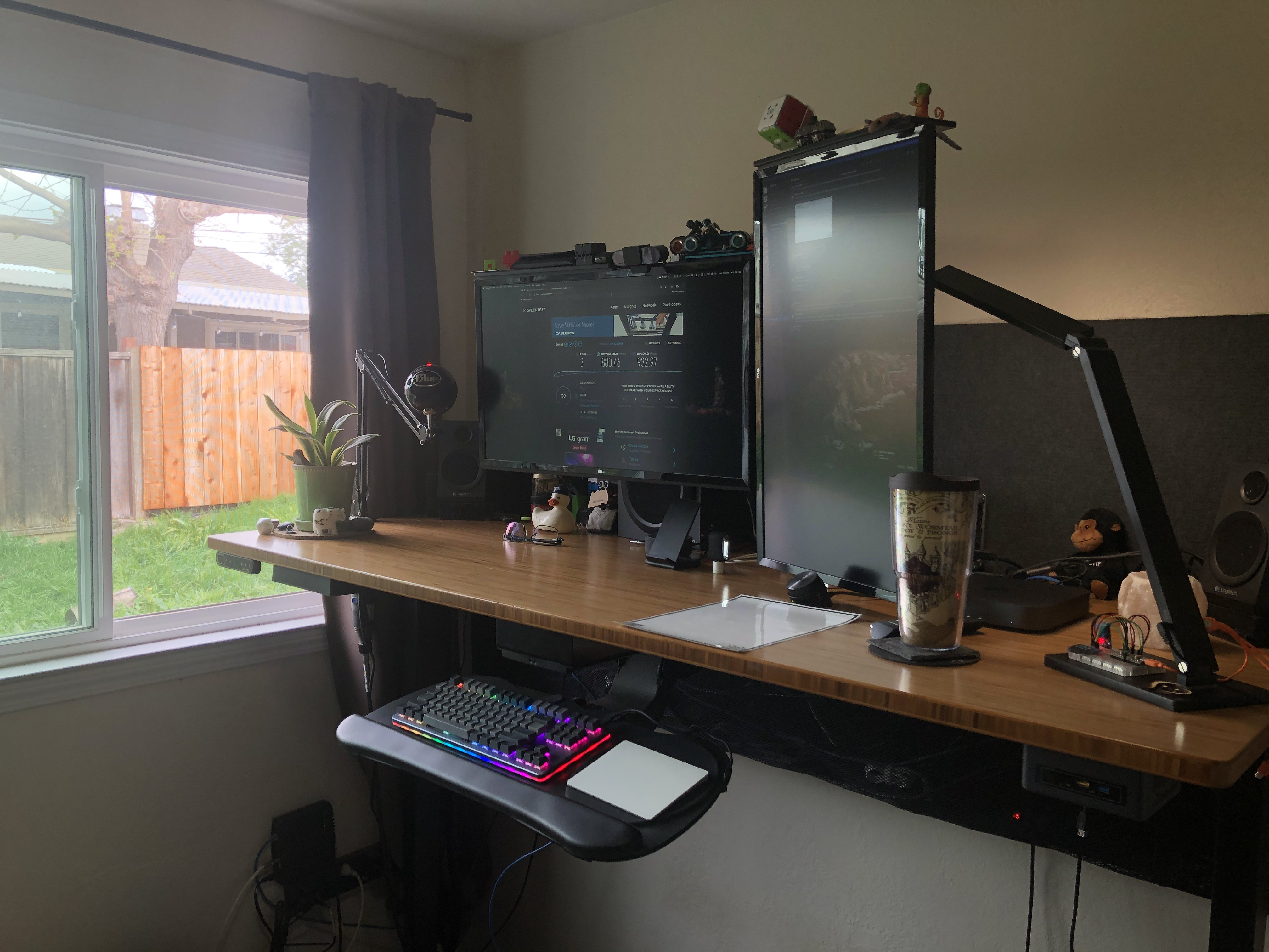 Two monitor workstation with window view on the left