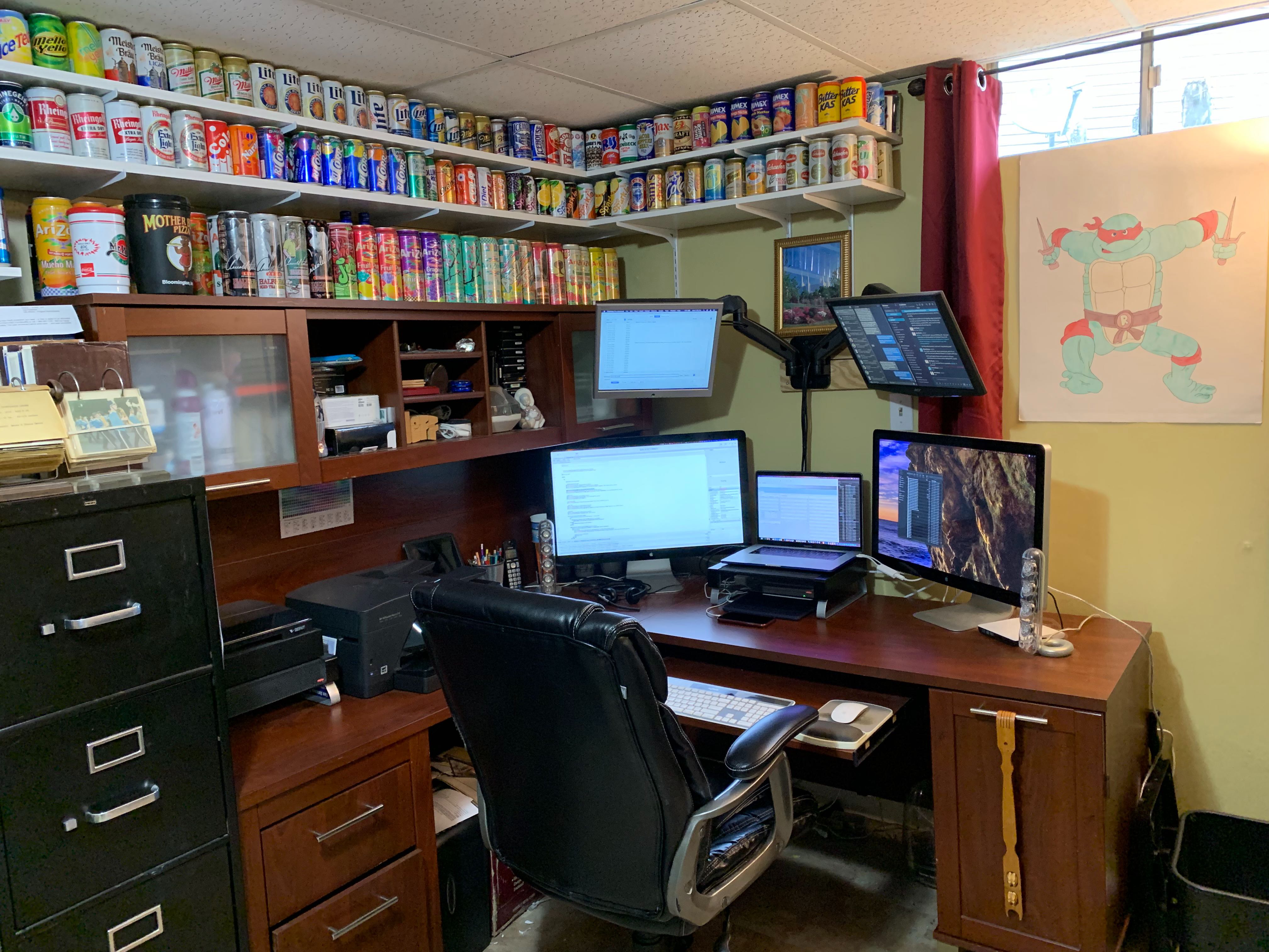 Four monitor workstation with shelves of beverage can collections